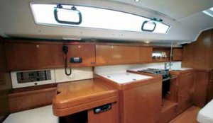 The Benetaeu Oceanis 40 navigation station and galley in the main cabin. Image courtesey & with permission of Beneteau S.A.