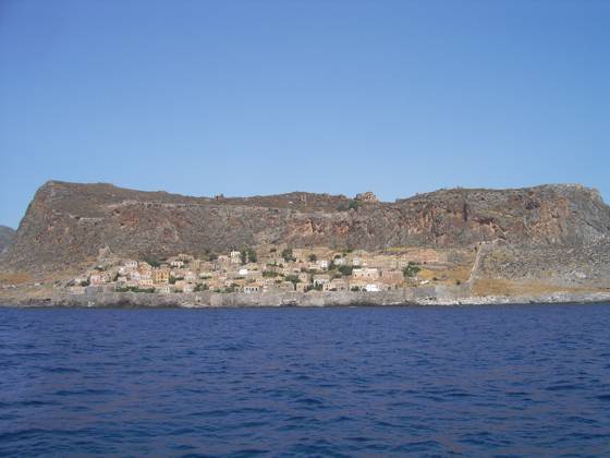 Sailing holiday locations in Greece: Looking north west at the medieval walled town of Monemvasia built below the earlier Byzantine town and fortress above