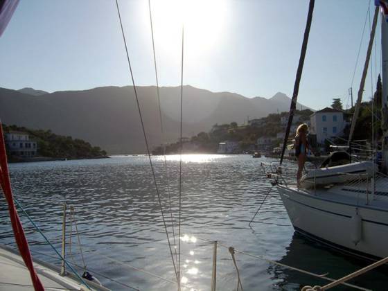 Sailing holiday locations in Greece: Looking up the ‘fjord’ at Yérakas with the village to the right and the salt water lagoon beyond through the narrows