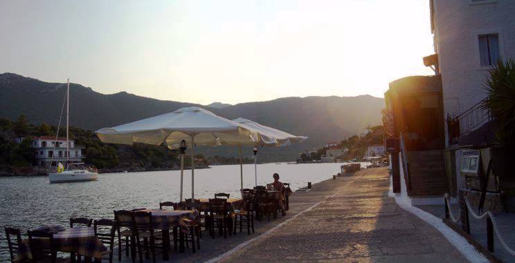 Sailing holiday locations in Greece: Relaxing on the quayside, Yérakas, as the sun sets behond the Pelopopnnese mainland