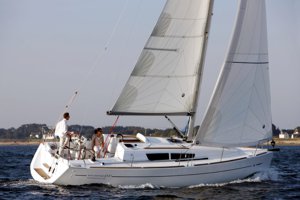A Jeanneau Sun Odyssey 33i sailing yacht underway. Please note this shows the Performance version of the 33i with cockpit-based mainsheet. Greek Sails 33i yachts have the mainsheet carried to the cabin roof just forward of the compnaionway